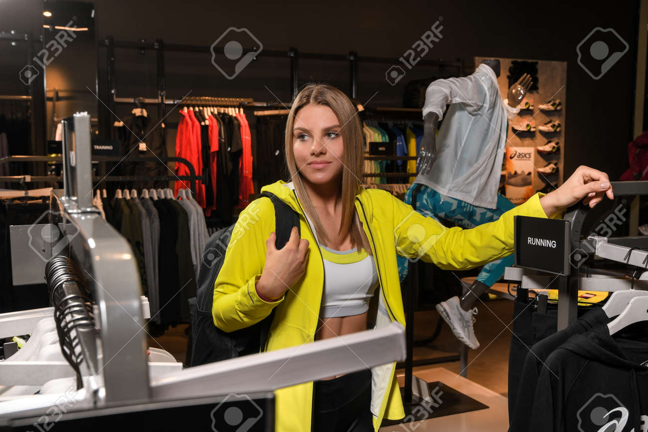 Skopje, North Macedonia - March 12, 2021: Asics store in Skopje, North Macedonia. Girl photo model wearing sports tracksuits and sneakers ASICS GEL, carrying a sports backpack on her shoulder - 166164685 Skopje, North Macedonia - March 12, 2021: Asics store in Skopje, North Macedonia. Girl photo model wearing sports tracksuits and sneakers ASICS GEL, carrying a sports backpack on her shoulder - 166164685