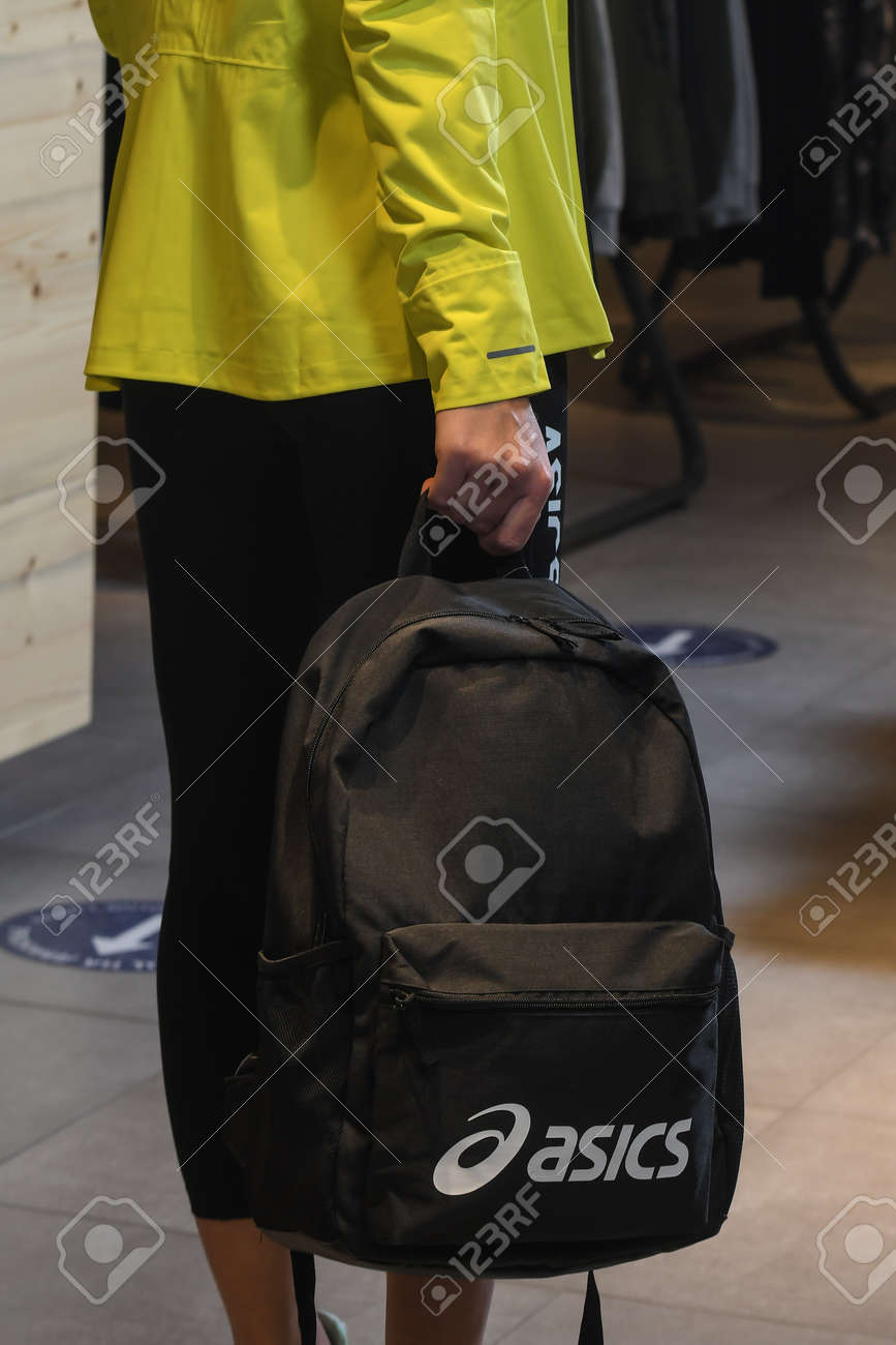 Skopje, North Macedonia - March 12, 2021: Asics store in Skopje, North Macedonia. Girl model wearing sports tracksuits and sneakers ASICS GEL, holding a sports backpack - 166241062 Skopje, North Macedonia - March 12, 2021: Asics store in Skopje, North Macedonia. Girl model wearing sports tracksuits and sneakers ASICS GEL, holding a sports backpack - 166241062
