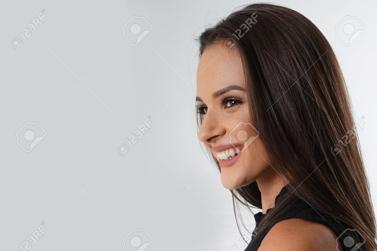 Portrait of an emotionally beautiful woman laughing while looking to the side. Beauty face portrait. Beautiful model girl with perfect fresh clean skin. Concept for youth and skin care - 166560983 Portrait of an emotionally beautiful woman laughing while looking to the side. Beauty face portrait. Beautiful model girl with perfect fresh clean skin. Concept for youth and skin care - 166560983