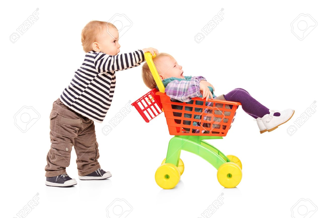 幼児男の子の白い背景で隔離の手押し車 彼の双子の妹を押す の写真素材 画像素材 Image