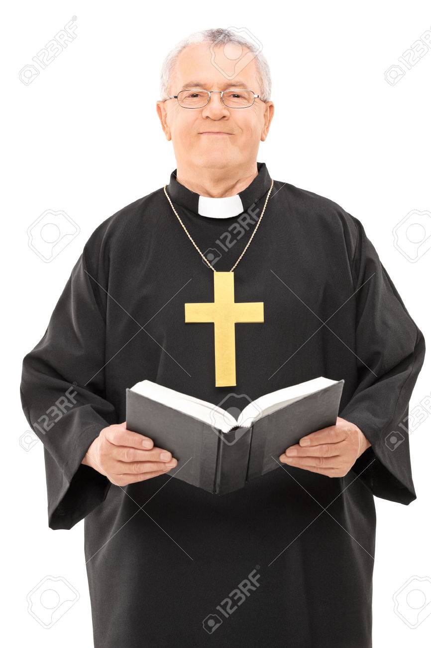happy mature priest holding a holy bible isolated on white