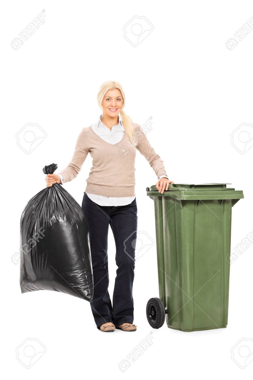Full length portrait of a woman holding a trash bag next to a garbage bin isolated on white background - 34007973 Full length portrait of a woman holding a trash bag next to a garbage bin isolated on white background - 34007973