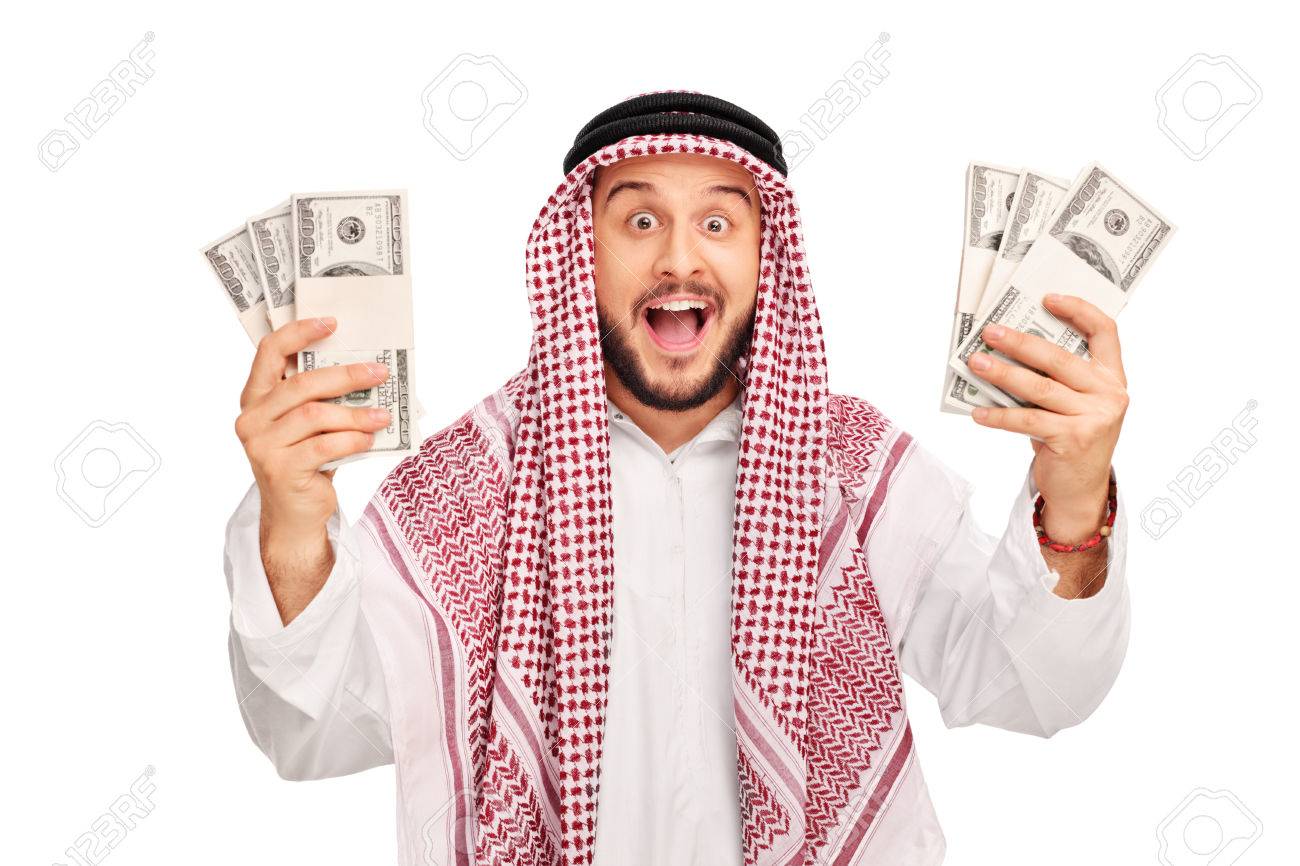 Excited Young Arab Holding Few Stacks Of Money And Looking At The Camera Isolated On White Background Stock Photo Picture And Royalty Free Image Image 47317296