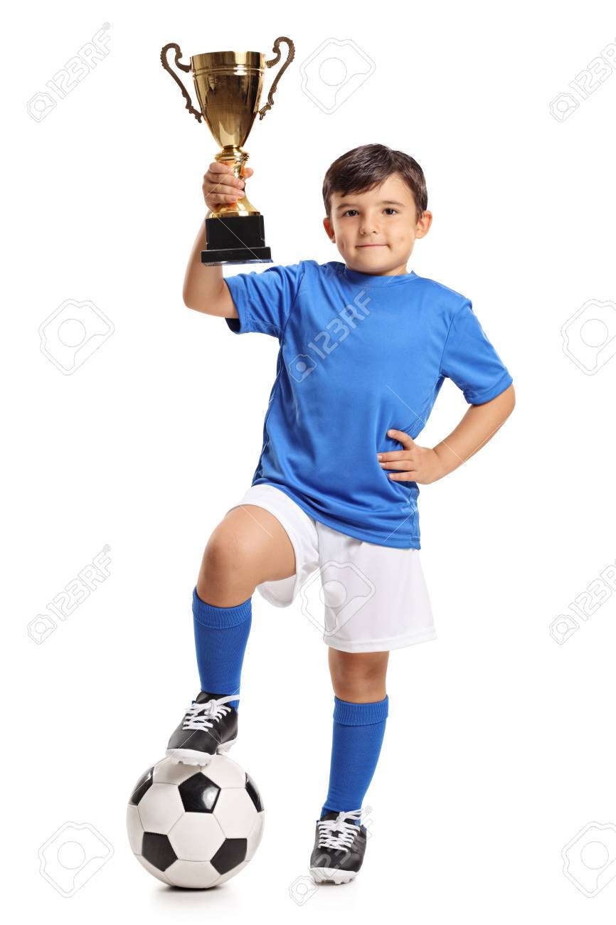 Full length portrait of a small boy in a blue jersey with a football and a gold trophy isolated on white background - 87592724 Full length portrait of a small boy in a blue jersey with a football and a gold trophy isolated on white background - 87592724