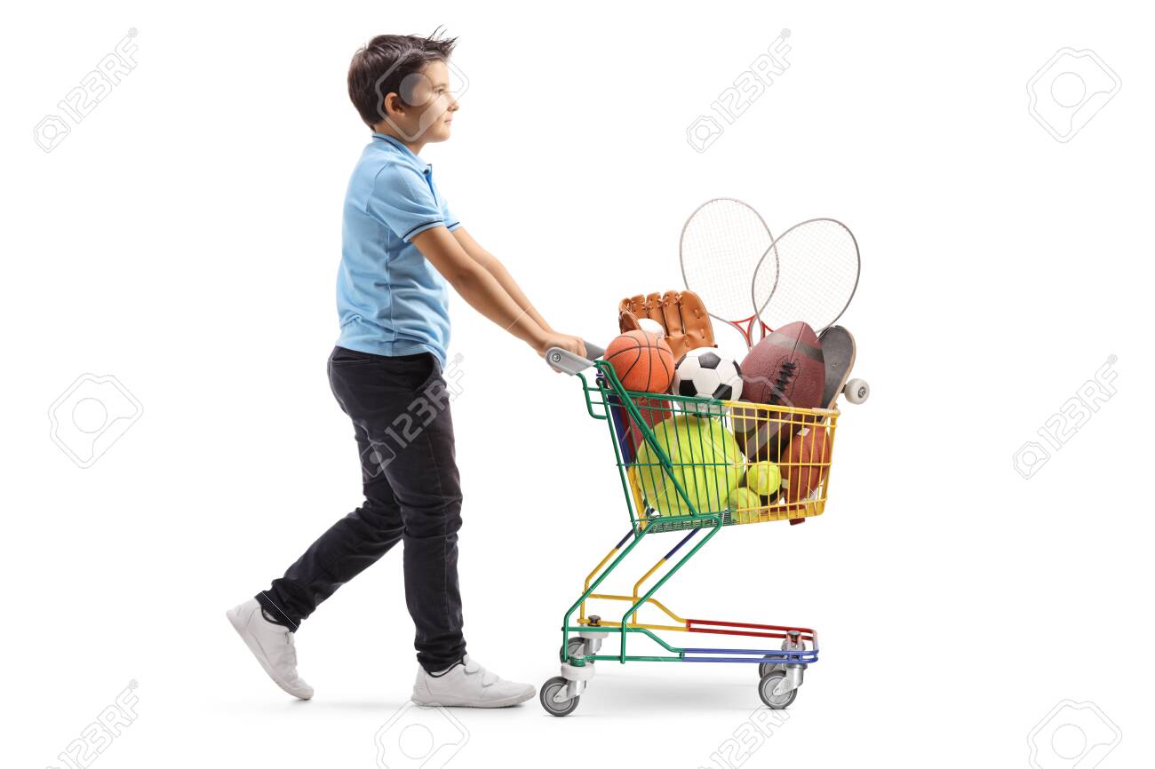 Full length profile shot of a boy walking and pushing a mini cart with sport items isolated on white background - 133106283 Full length profile shot of a boy walking and pushing a mini cart with sport items isolated on white background - 133106283