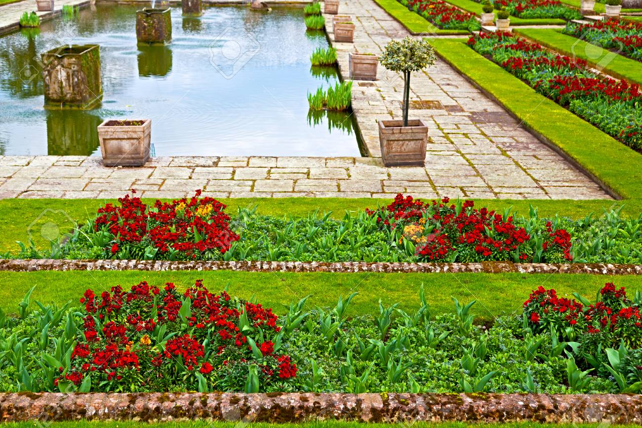 In London Old Garden Flowers And Plant Near A Fountain - 
