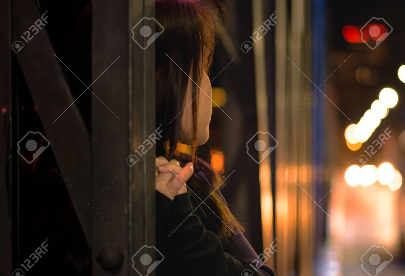 grild standing and leaned in metal bridge for awaiting someone
