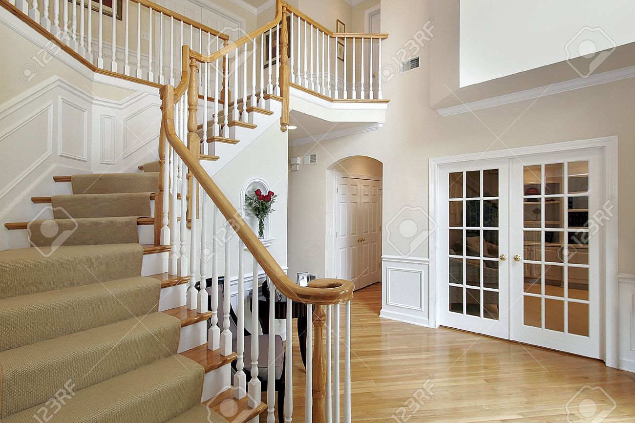 Foyer In Luxury Home With Wood Staircase Stock Photo Picture And