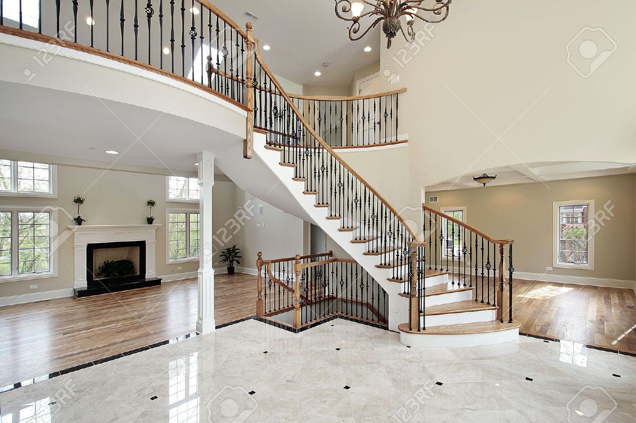 Foyer With Curved Staircase In Luxury Home Stock Photo, Picture And Foyer With Curved Staircase In Luxury Home Stock Photo, Picture And