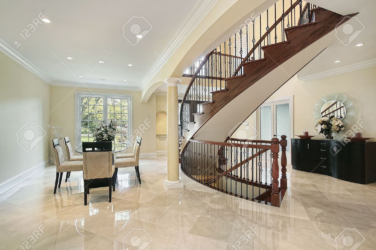 Foyer In Luxury Home With Curved Staircase Stock Photo Picture