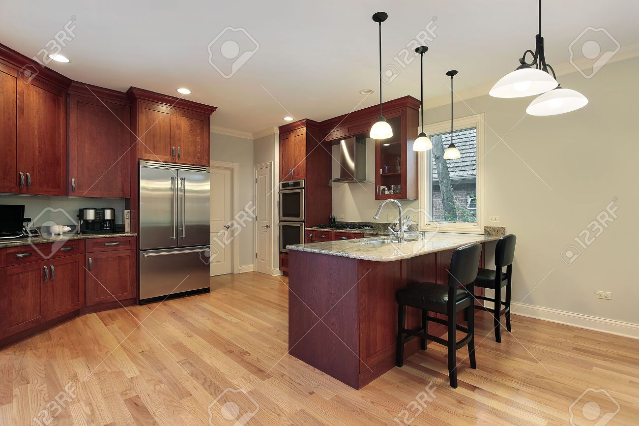 kitchen in luxury home with cherry wood cabinetry stock photo kitchen in luxury home with cherry wood cabinetry stock photo
