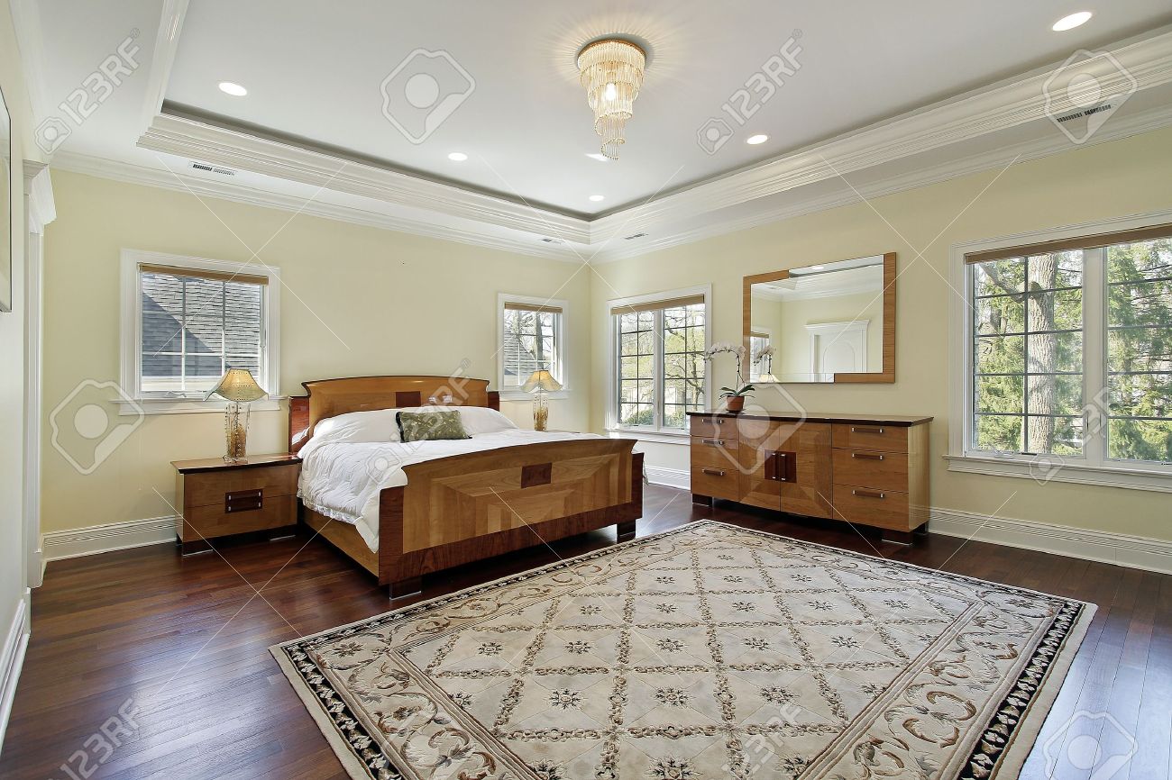 Master Bedroom In Luxury Home With Tray Ceiling Stock Photo
