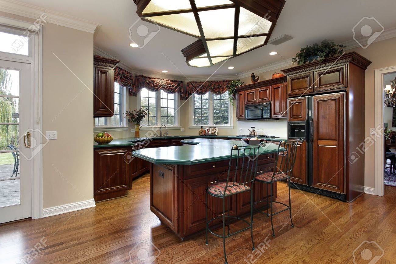 Kitchen With Dark Wood Cabinets And Green Island Counter Stock Kitchen With Dark Wood Cabinets And Green Island Counter Stock