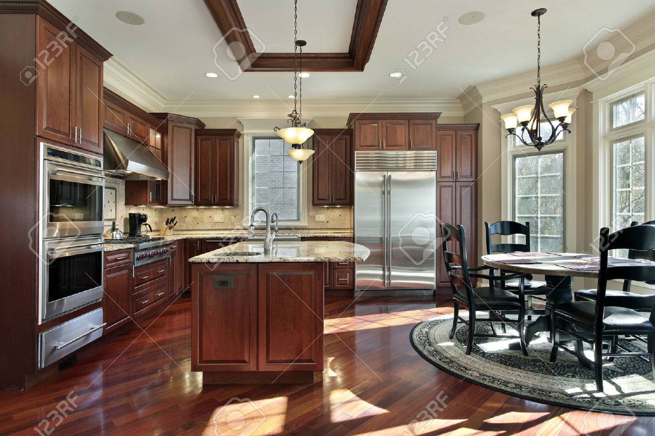 Luxury Kitchen With Cherry Wood Cabinetry And Eating Area Stock