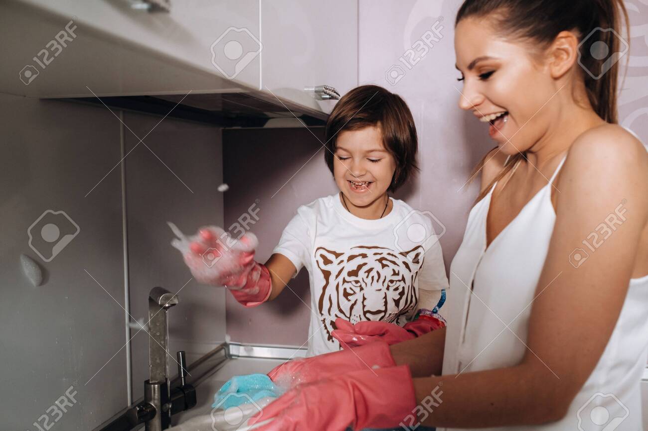 Housewife Mom In Pink Gloves Washes