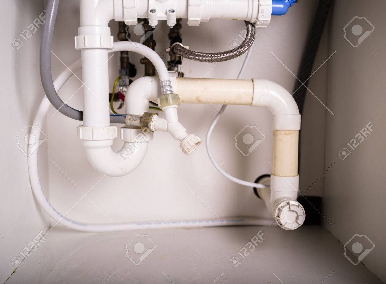 Piepes And Plumbing Under A Kitchen Sink Stock Photo Picture And Piepes And Plumbing Under A Kitchen Sink Stock Photo Picture And