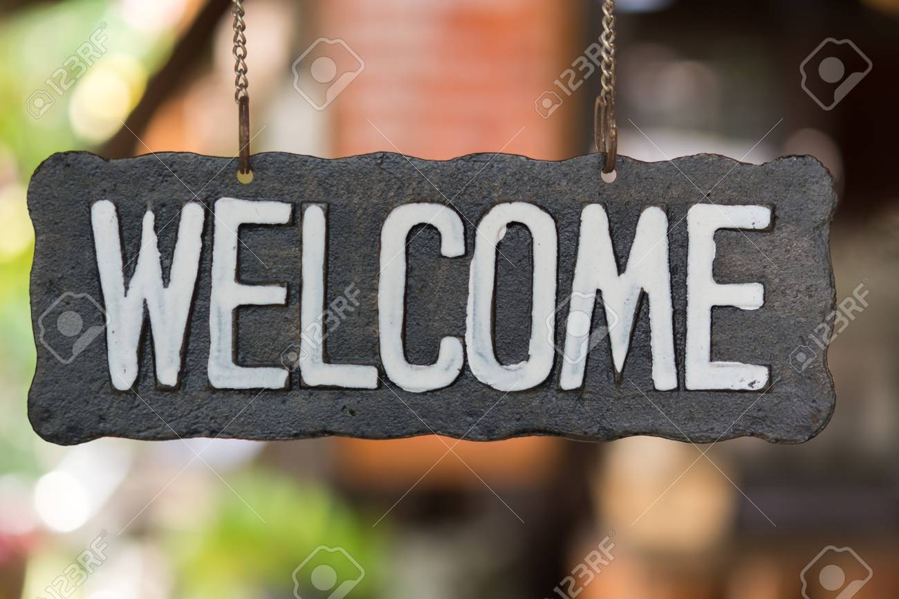 Welcome vintage wooden sign on a soft background blur. - 58137120 Welcome vintage wooden sign on a soft background blur. - 58137120