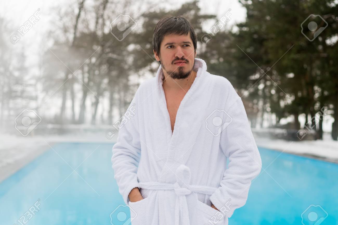 Young Man In Bathrobe Near Outdoor Swimming Pool At Winter Day Stock Young Man In Bathrobe Near Outdoor Swimming Pool At Winter Day Stock