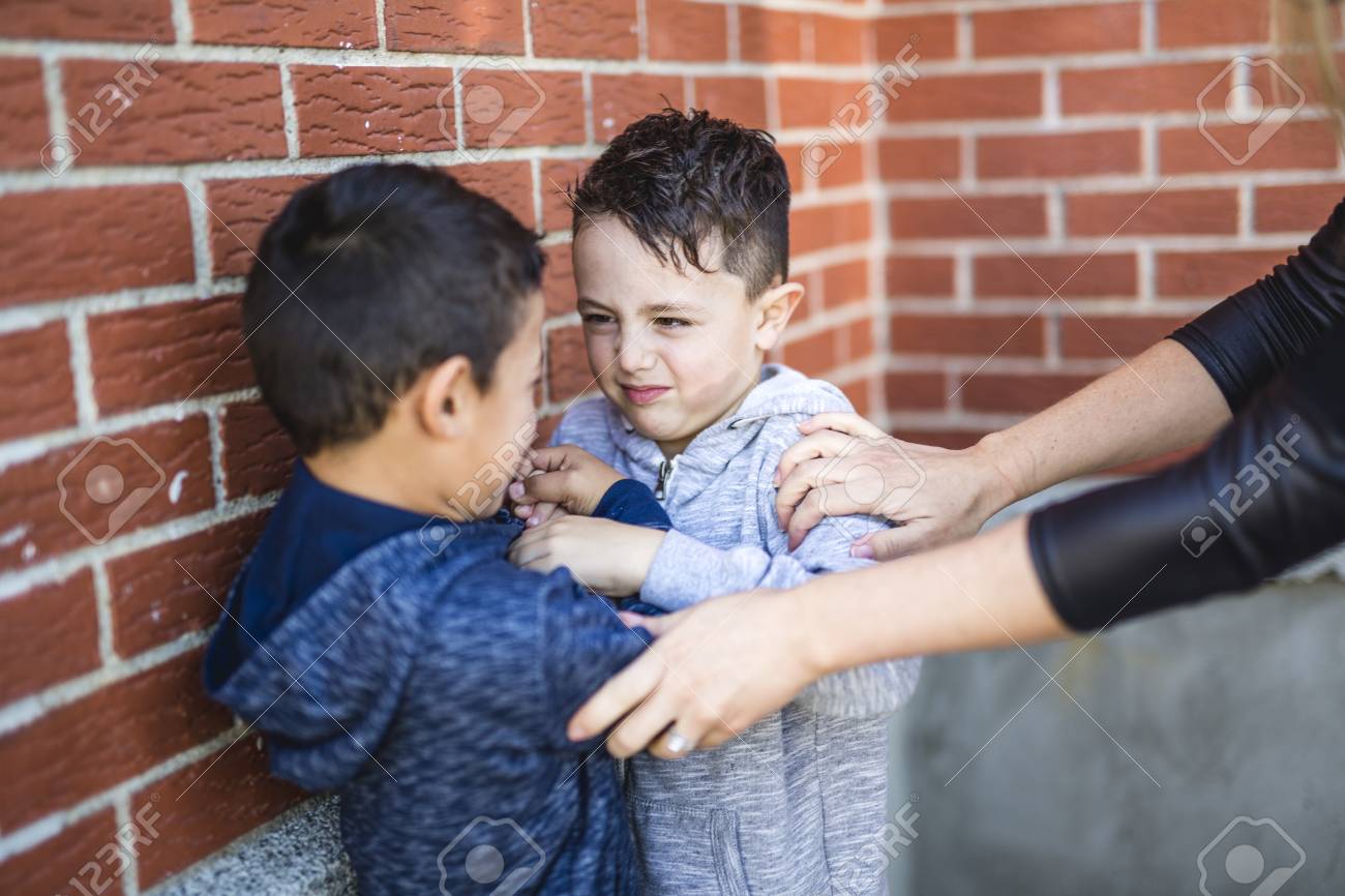 Teacher Stopping Two Boys Fighting In Playground - 86942541 Teacher Stopping Two Boys Fighting In Playground - 86942541