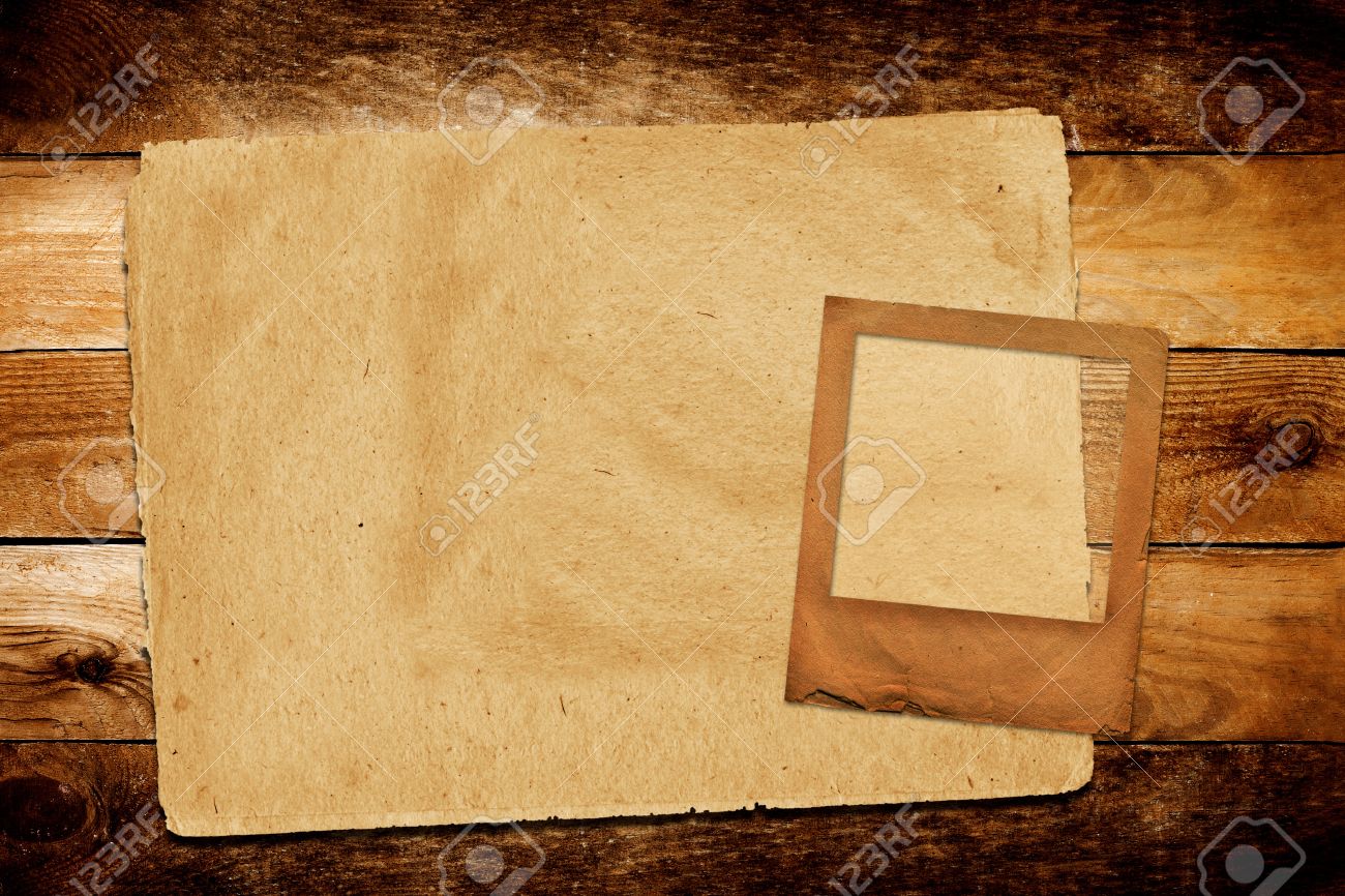 old grunge paper slide on the wooden background stock photo picture