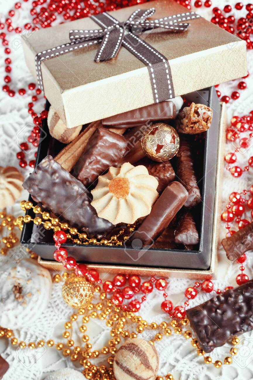 Golden Box Of Chocolates Cookies And Biscuits On Festive Table