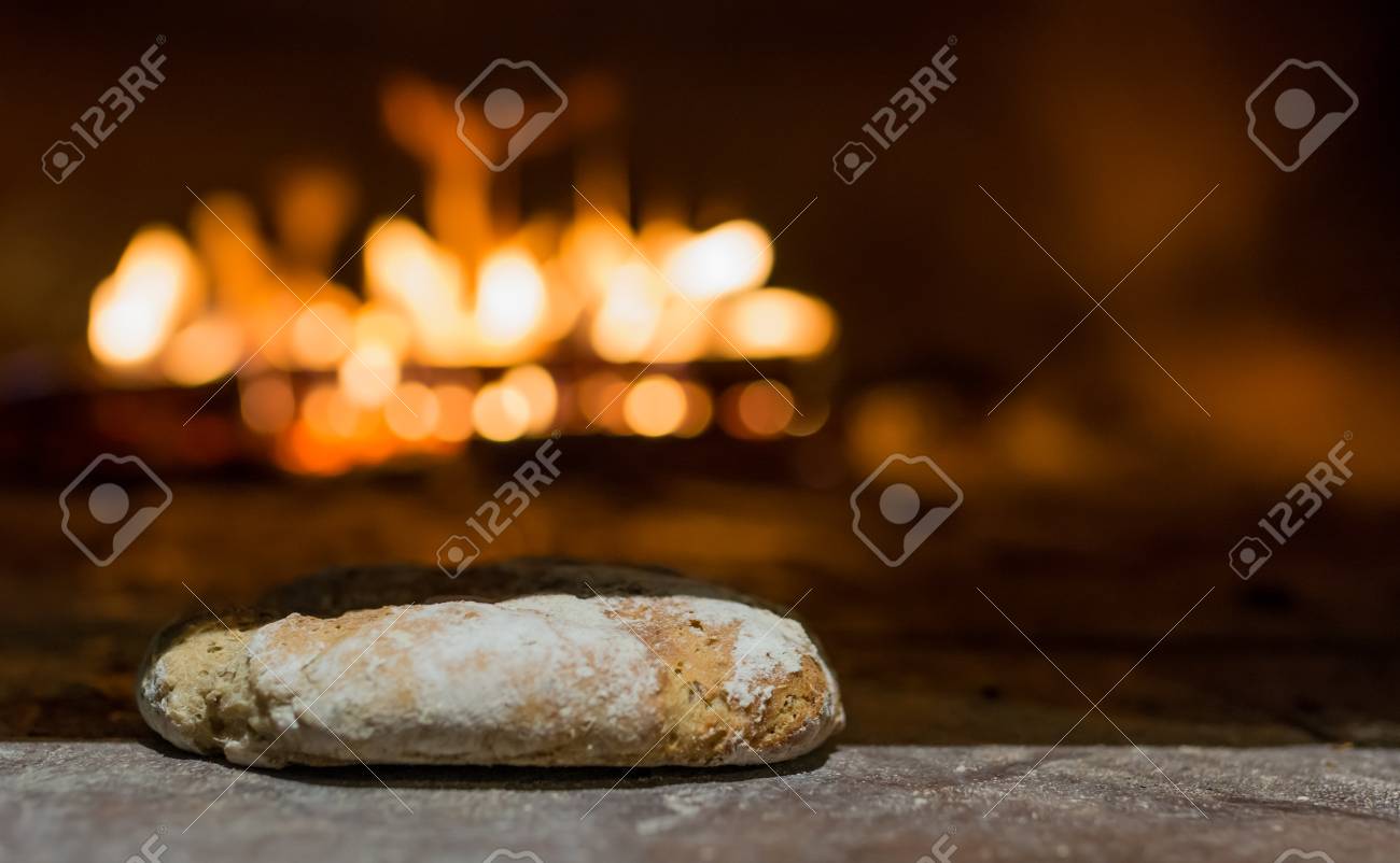 Freshly Baked Bread In Rustic Bakery With Traditional Stone Oven