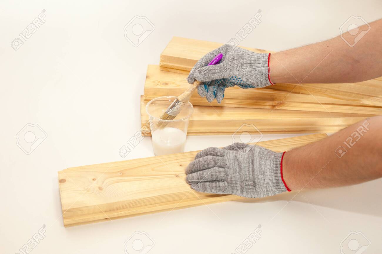 The Man Handles The Board Primer Processing Of Pine Boards