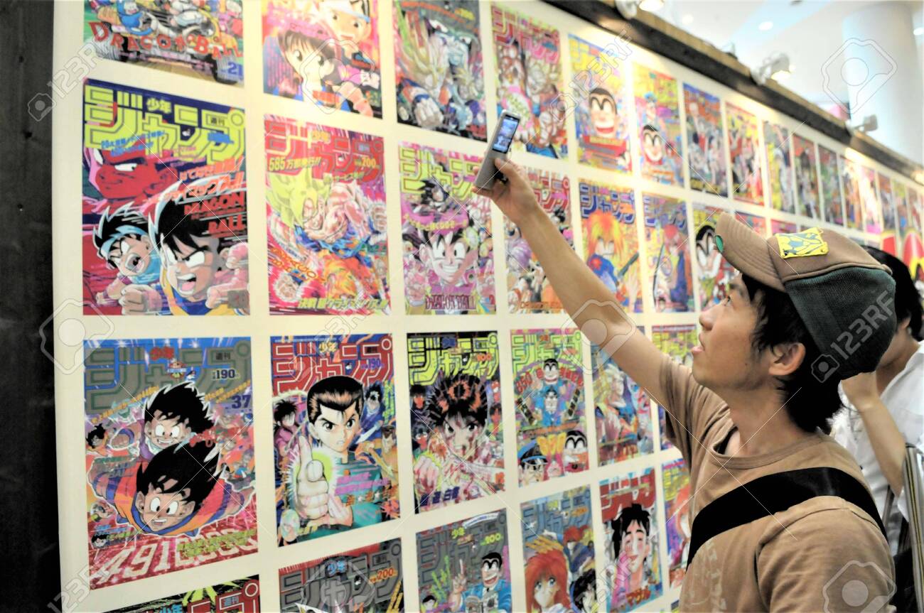 Japan Tokyo A Young Man In Front Of A Wall Full Of Manga Comics Stock Photo Picture And Royalty Free Image Image