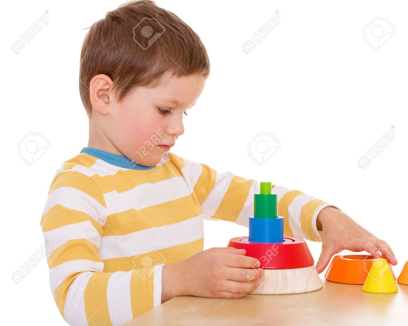 A little boy plays with a toy pyramid - 28214753 A little boy plays with a toy pyramid - 28214753