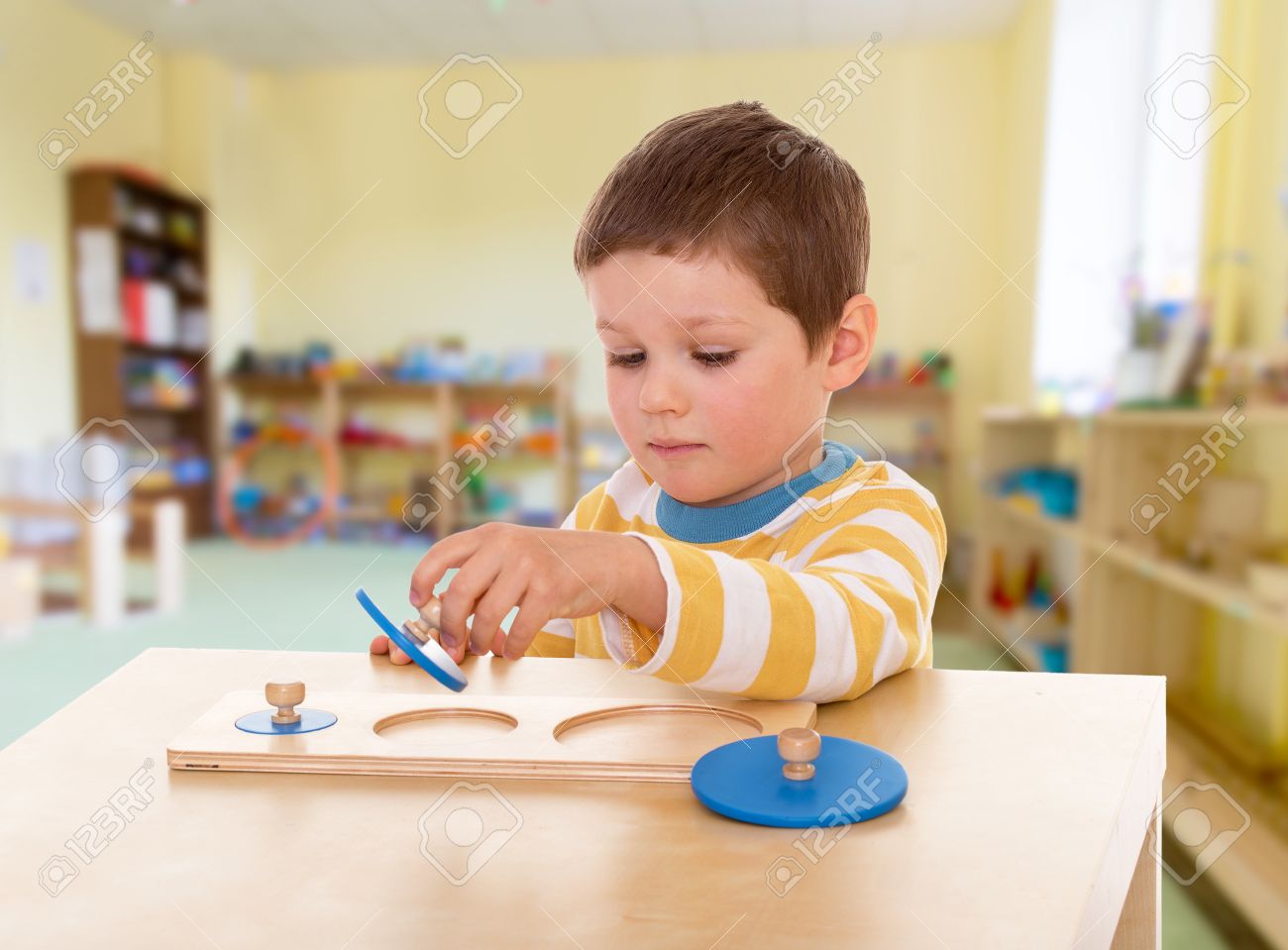 Boy engaged in the Montessori classroom kindergarten, the concept of childhood and joy, teens - 30362096 Boy engaged in the Montessori classroom kindergarten, the concept of childhood and joy, teens - 30362096