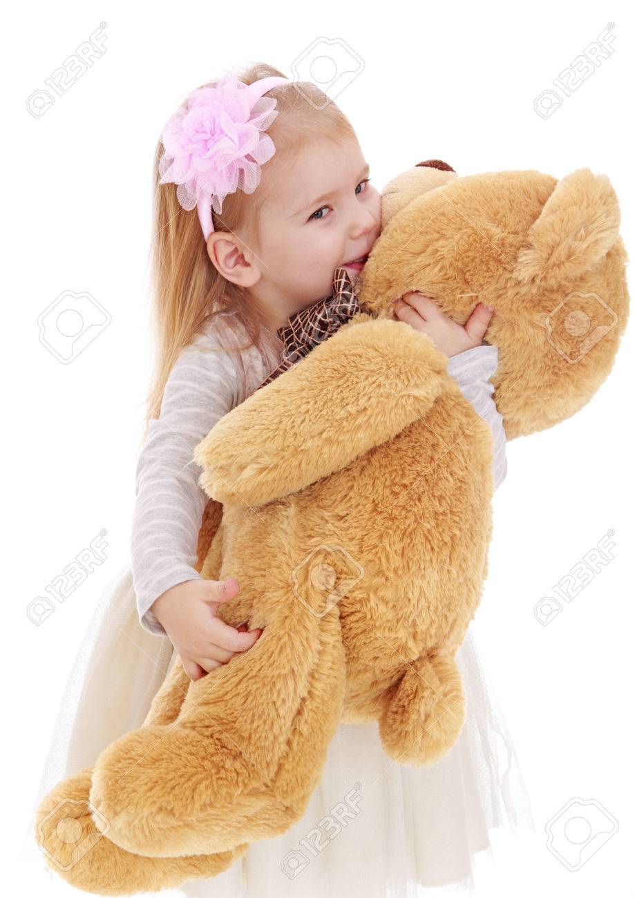 little girl hugging teddy bear