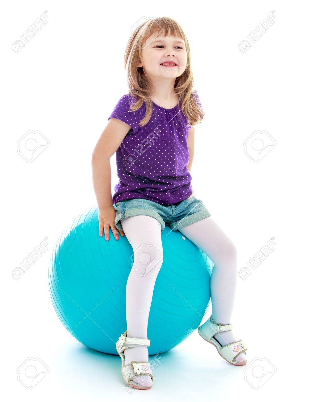 Little girl in short shorts sitting on the big blue linen.Isolated on white. - 36508711 Little girl in short shorts sitting on the big blue linen.Isolated on white. - 36508711
