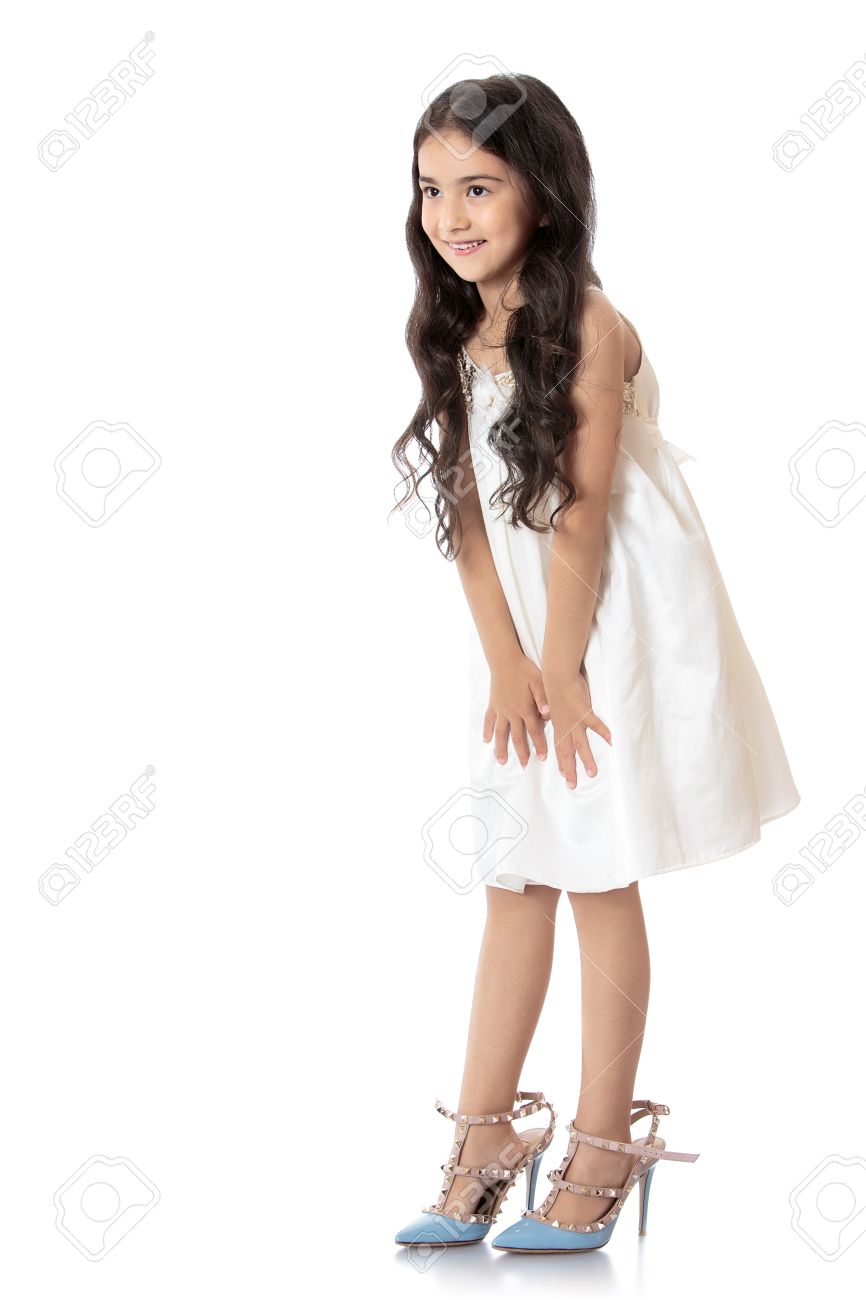 Elegant, slim little girl of Eastern appearance, with long dark hair, trying on mom's high-heeled shoes. Shoes on the feet of the girls are very large - Isolated on white background - 49208974 Elegant, slim little girl of Eastern appearance, with long dark hair, trying on mom's high-heeled shoes. Shoes on the feet of the girls are very large - Isolated on white background - 49208974