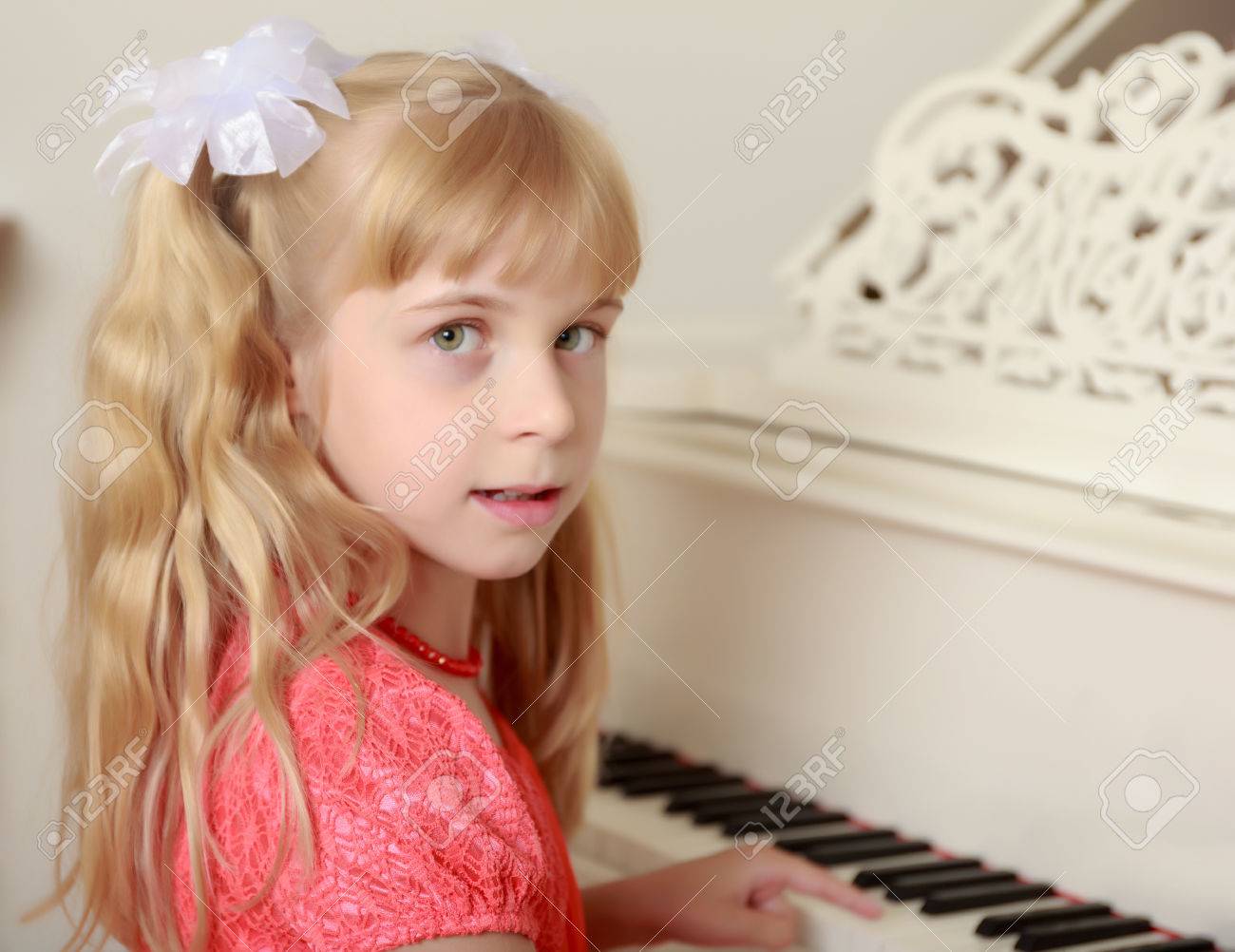 Beautiful Little Girl In A Long Orange Dress With Long Blond
