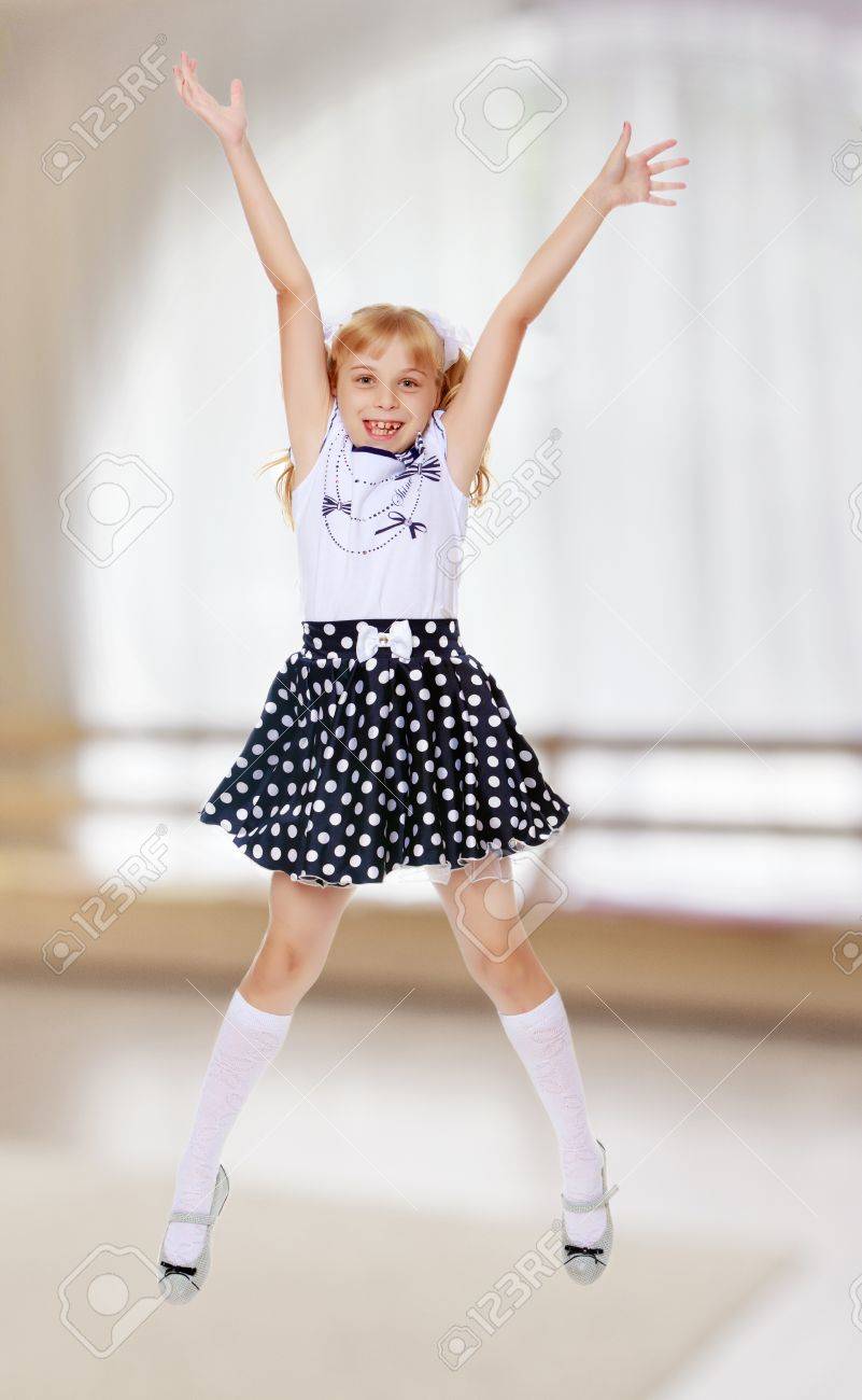 Cheerful Little Girl Short Skirt Polka Dot Jumps With Her Arms And Legs In A Room With A Large Semi Circular Window Stock Photo Picture And Royalty Free Image Image 6565