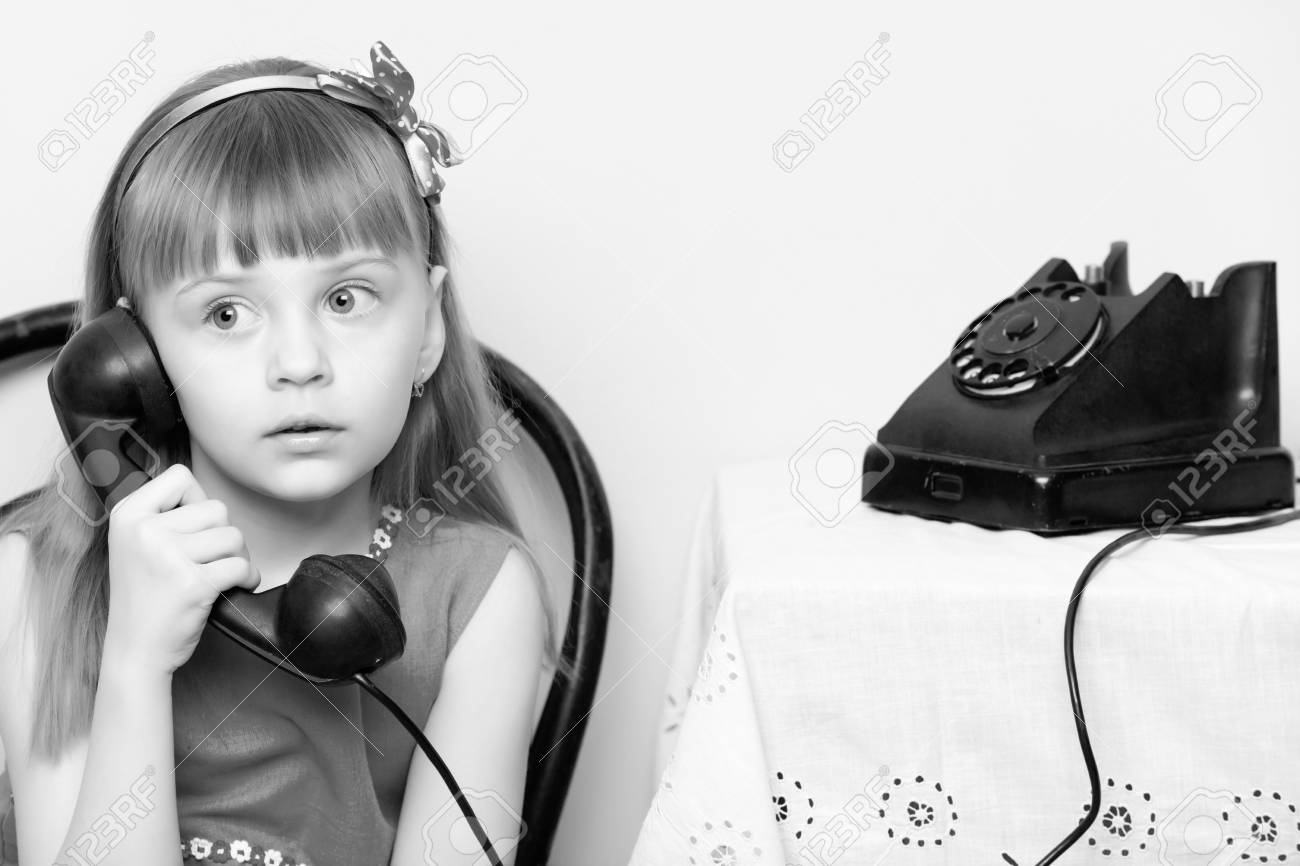 The Girl Is Talking On A Black, Old Phone With A Spinning Disc. Stock  Photo, Picture and Royalty Free Image. Image 91600005., image size:1300x866