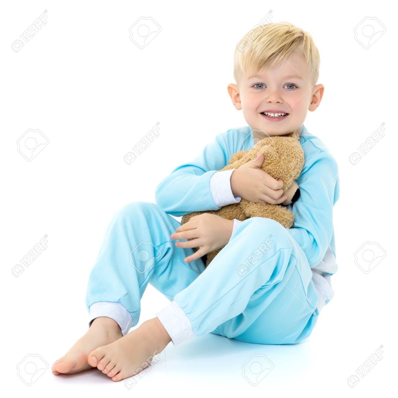 Little Boy In Pajamas With A Teddy Bear 