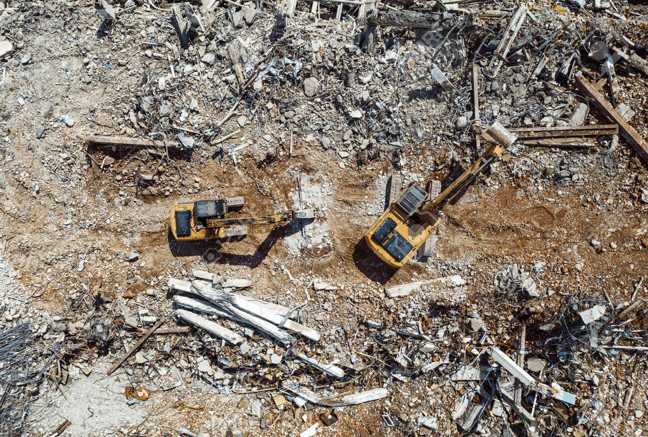 Excavators demolishing old factory for new construction project, aerial top view - 129152629 Excavators demolishing old factory for new construction project, aerial top view - 129152629