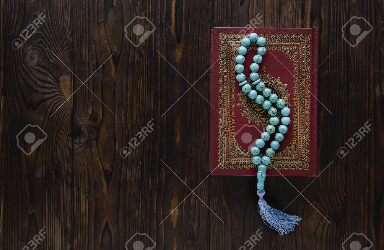 Koran with rosary beads on wooden background. Islamic concept with copy space - 129083803 Koran with rosary beads on wooden background. Islamic concept with copy space - 129083803