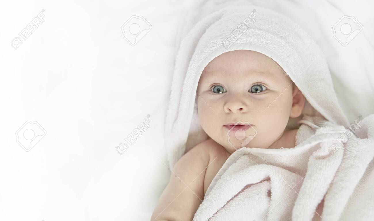cute happy little baby in white towel - 129009284 cute happy little baby in white towel - 129009284