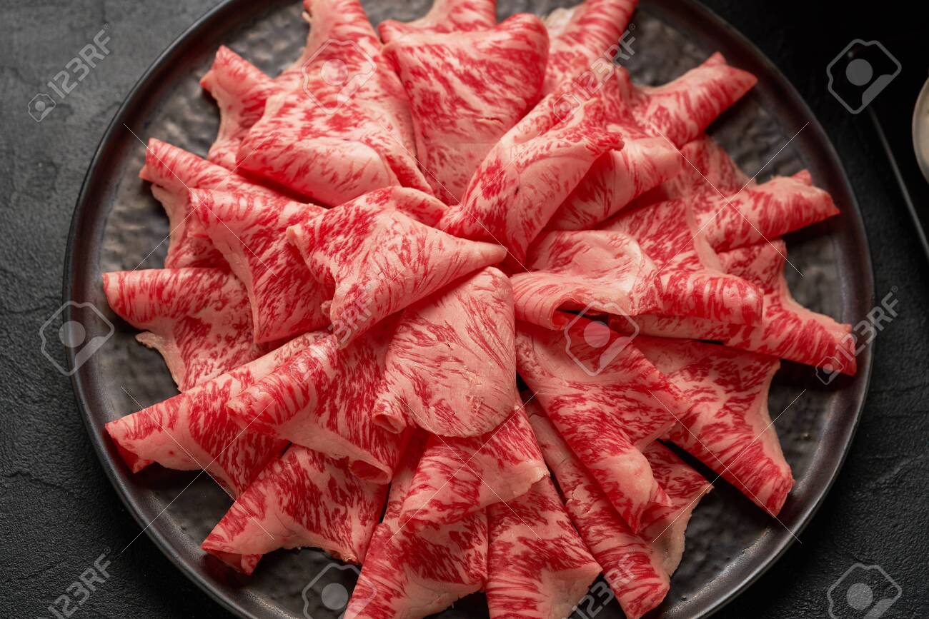 A close up detailed image of sliced Japanese wagyu beef in a ceramic plate prepared for Shabu Shab - 131905222 A close up detailed image of sliced Japanese wagyu beef in a ceramic plate prepared for Shabu Shab - 131905222