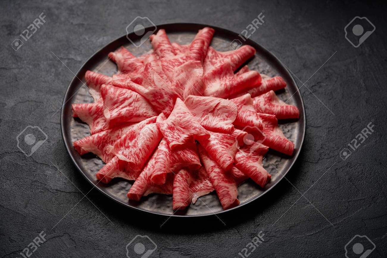 Japanese kobe beef sliced on plate prepared for shabu shabu on black background - 131905089 Japanese kobe beef sliced on plate prepared for shabu shabu on black background - 131905089