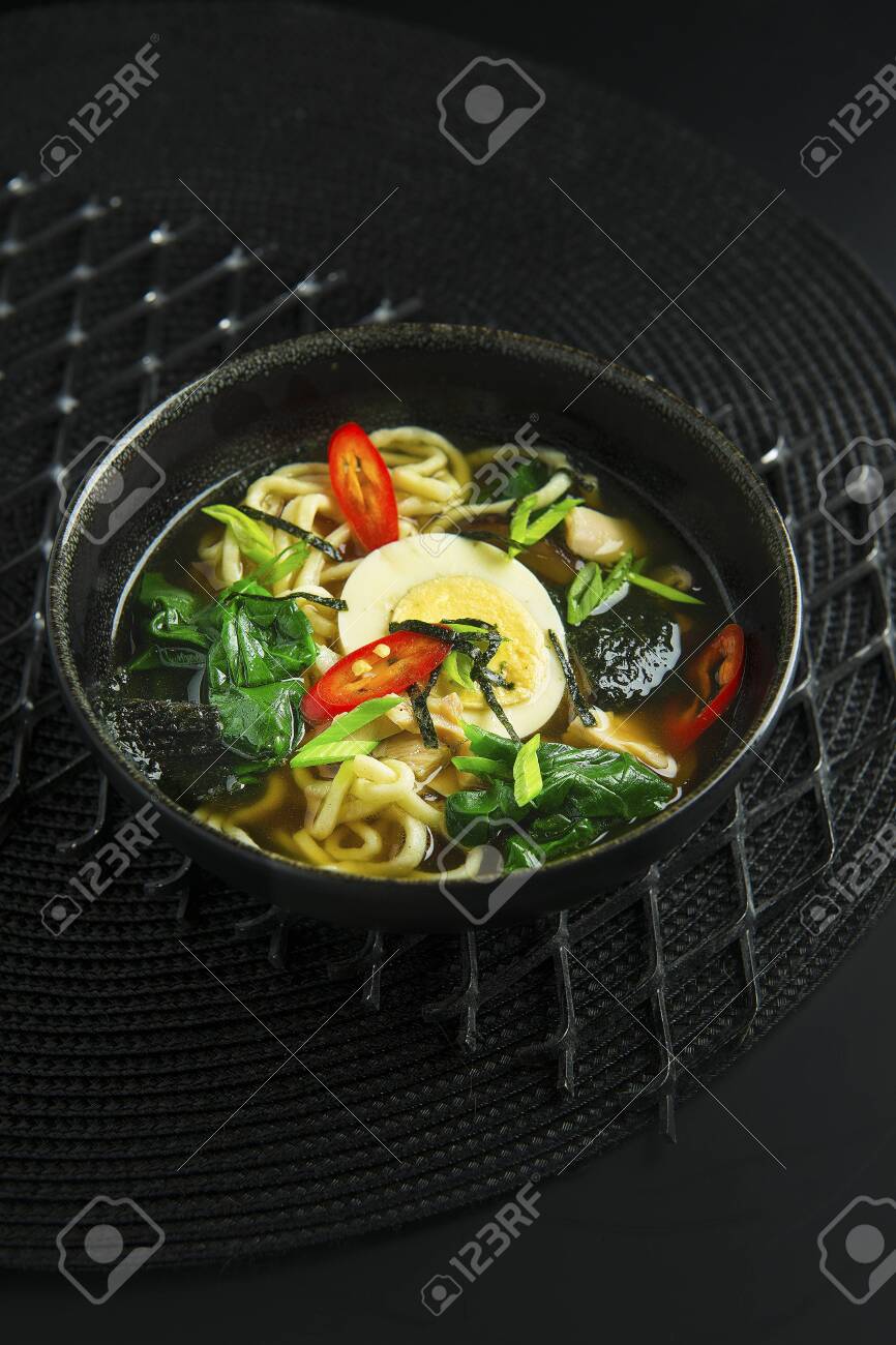 Traditional asian soup in bowl on black background - 133112034 Traditional asian soup in bowl on black background - 133112034