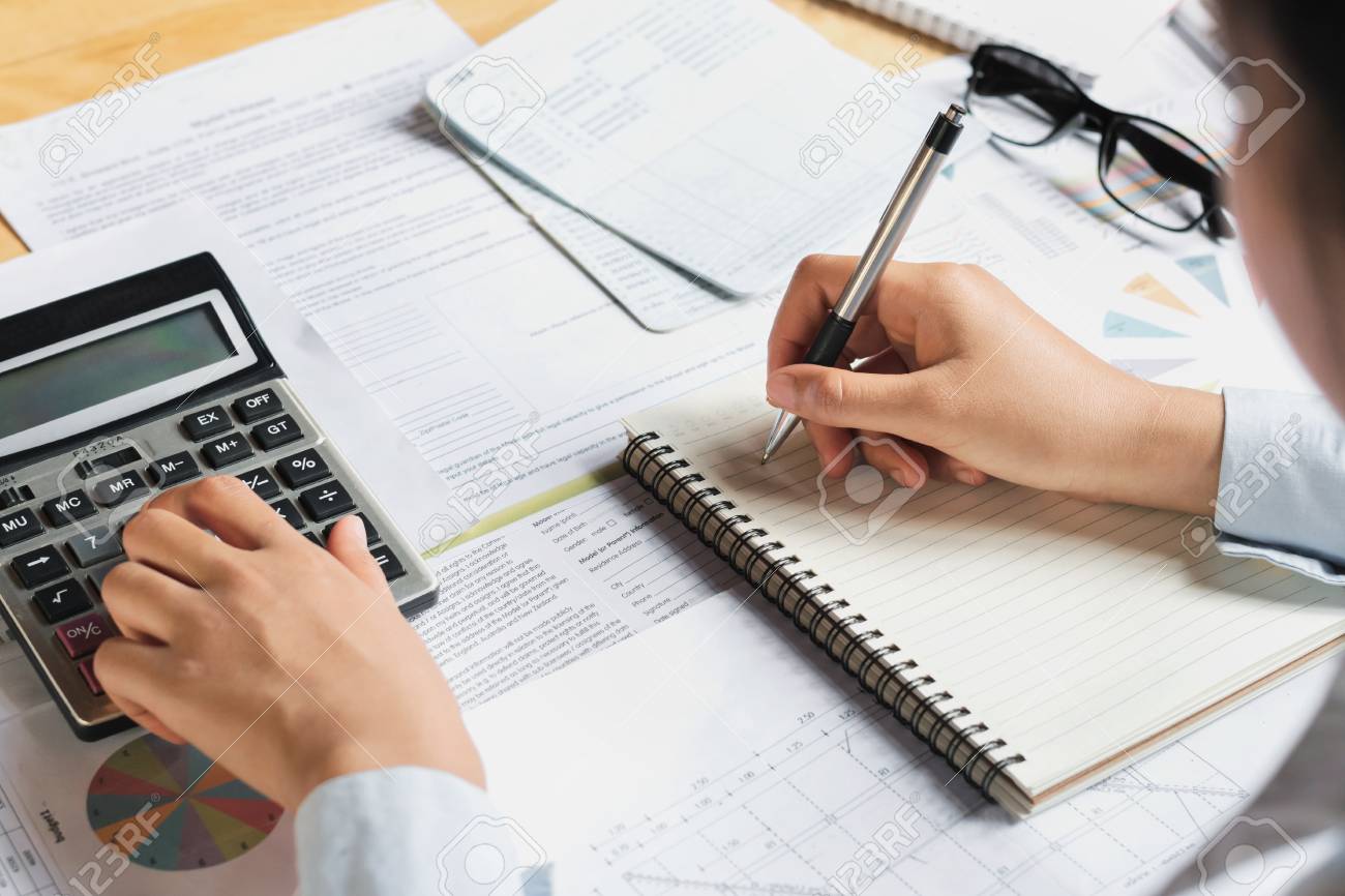 accountant using calculator for calculate budget finance on table