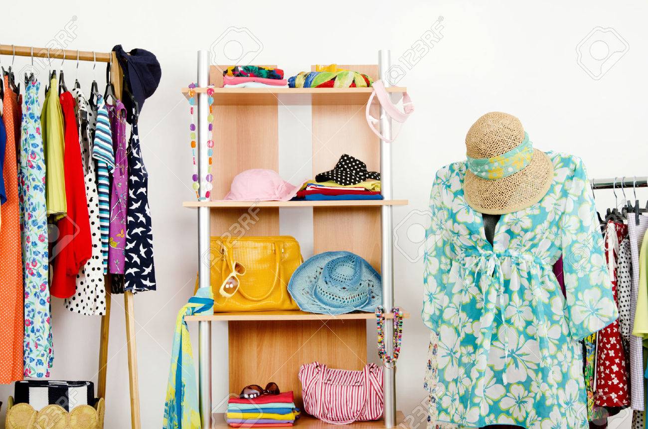 Wardrobe With Summer Clothes Nicely Arranged And A Beach Outfit