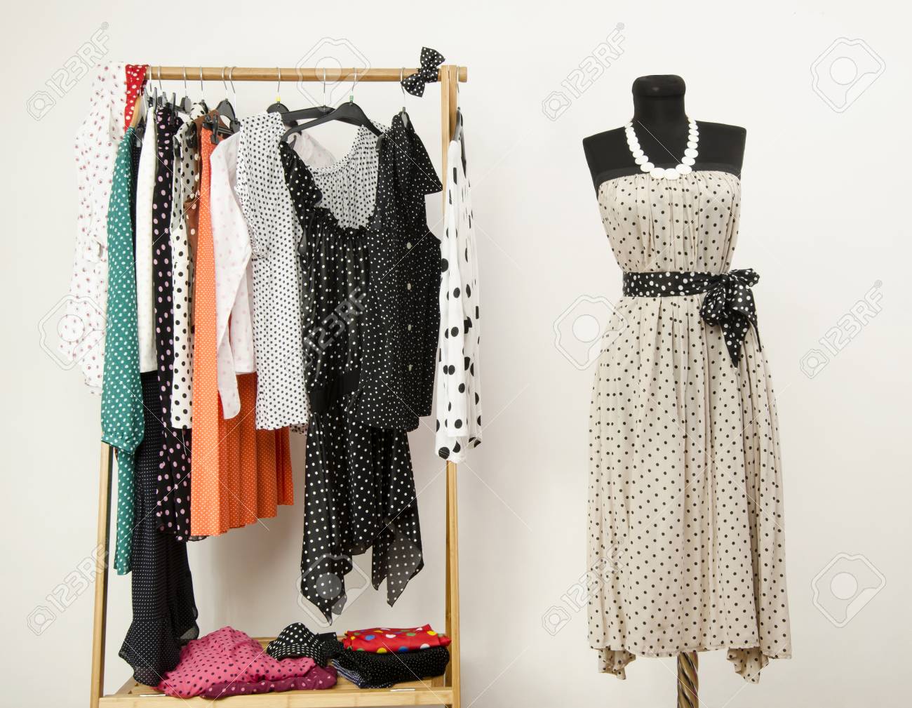 Dressing Closet With Polka Dots Clothes Arranged On Hangers And