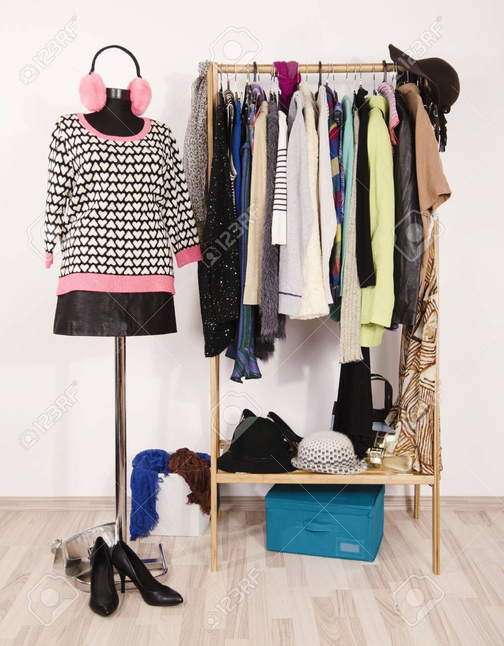 Wardrobe With Winter Clothes Arranged On Hangers And An Outfit