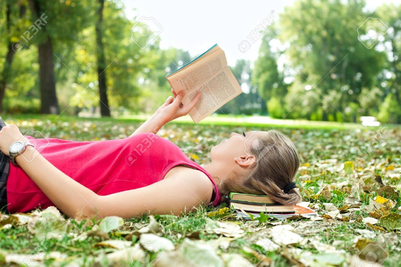 young woman relaxing and reading book stock photo picture and