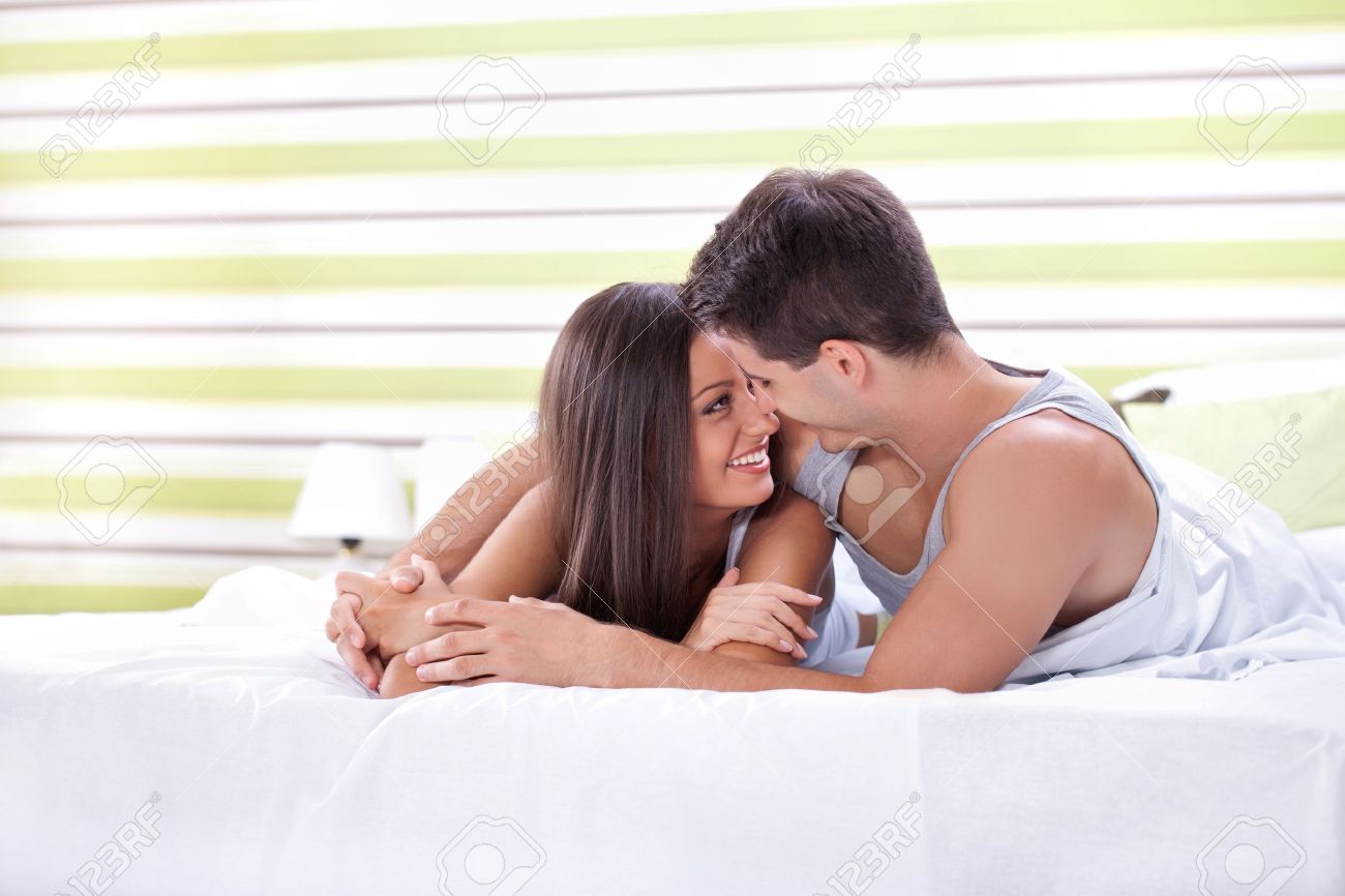 Young Love Couple In Bed Romantic Scene In Bedroom