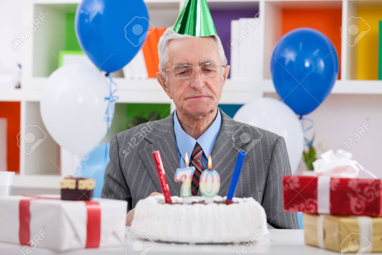Senior Man Looking At His Birthday Cake For 70th Birthday Stock Photo Picture And Royalty Free Image Image